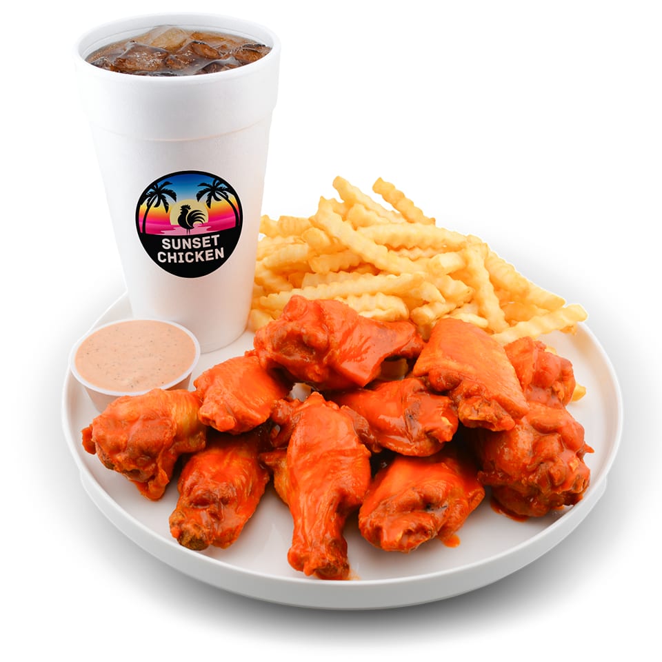 Plate of saucy chicken wings with crinkle-cut fries, dipping sauce, and iced soda branded Sunset Chicken.